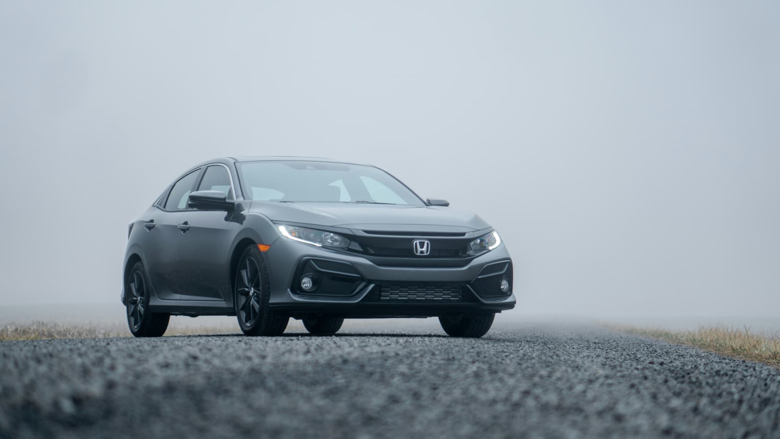 Gray Honda Civic sedan on a foggy road