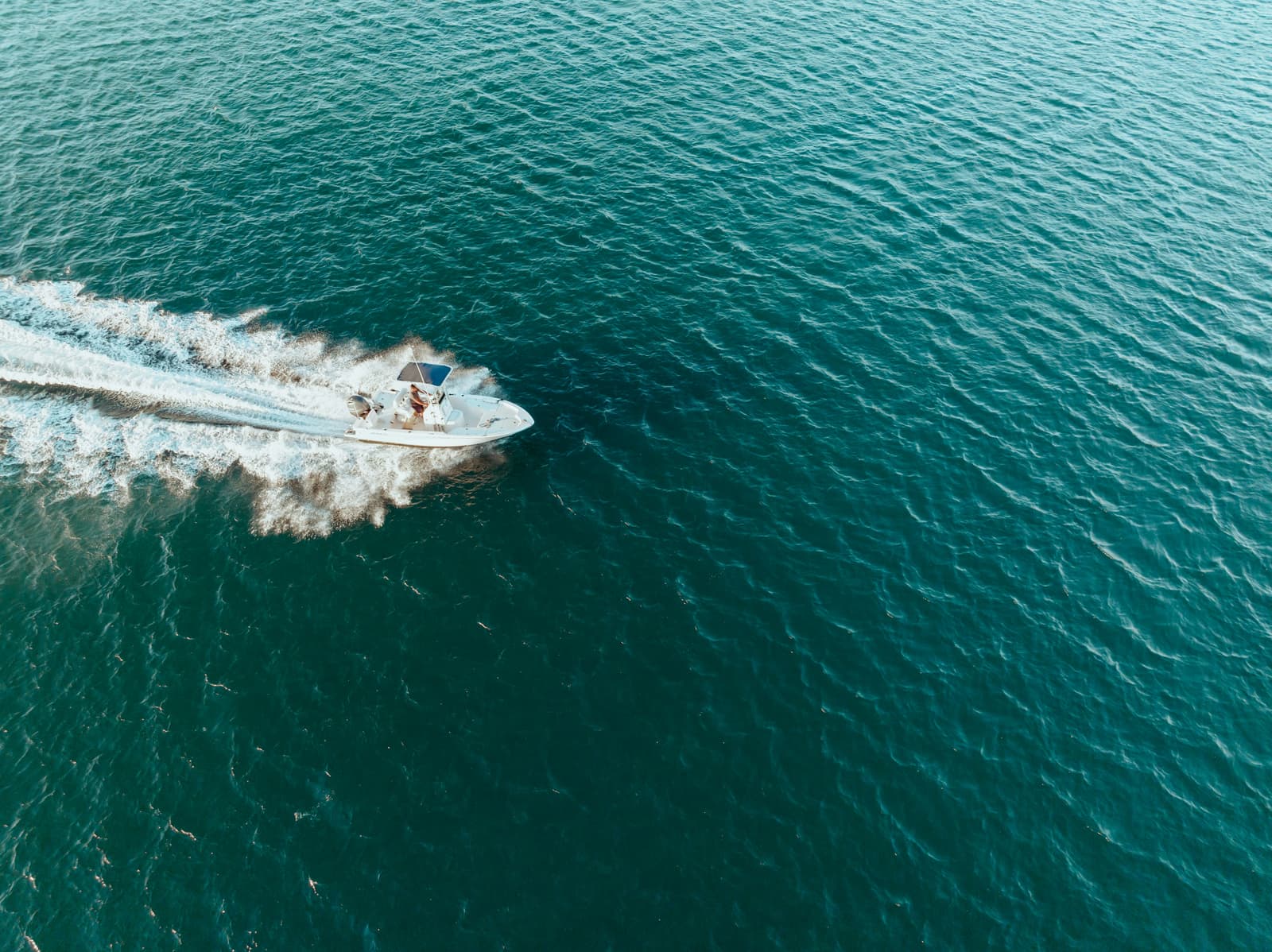 Aerial view of center console boat cruising on open water