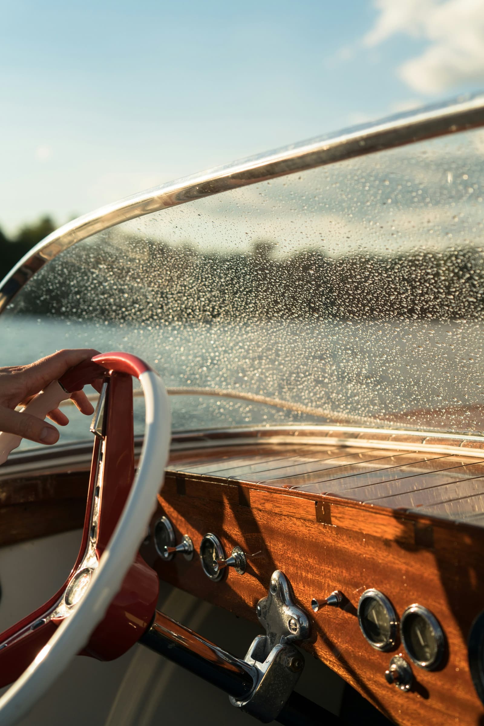 Classic wooden boat steering wheel and dashboard close-up